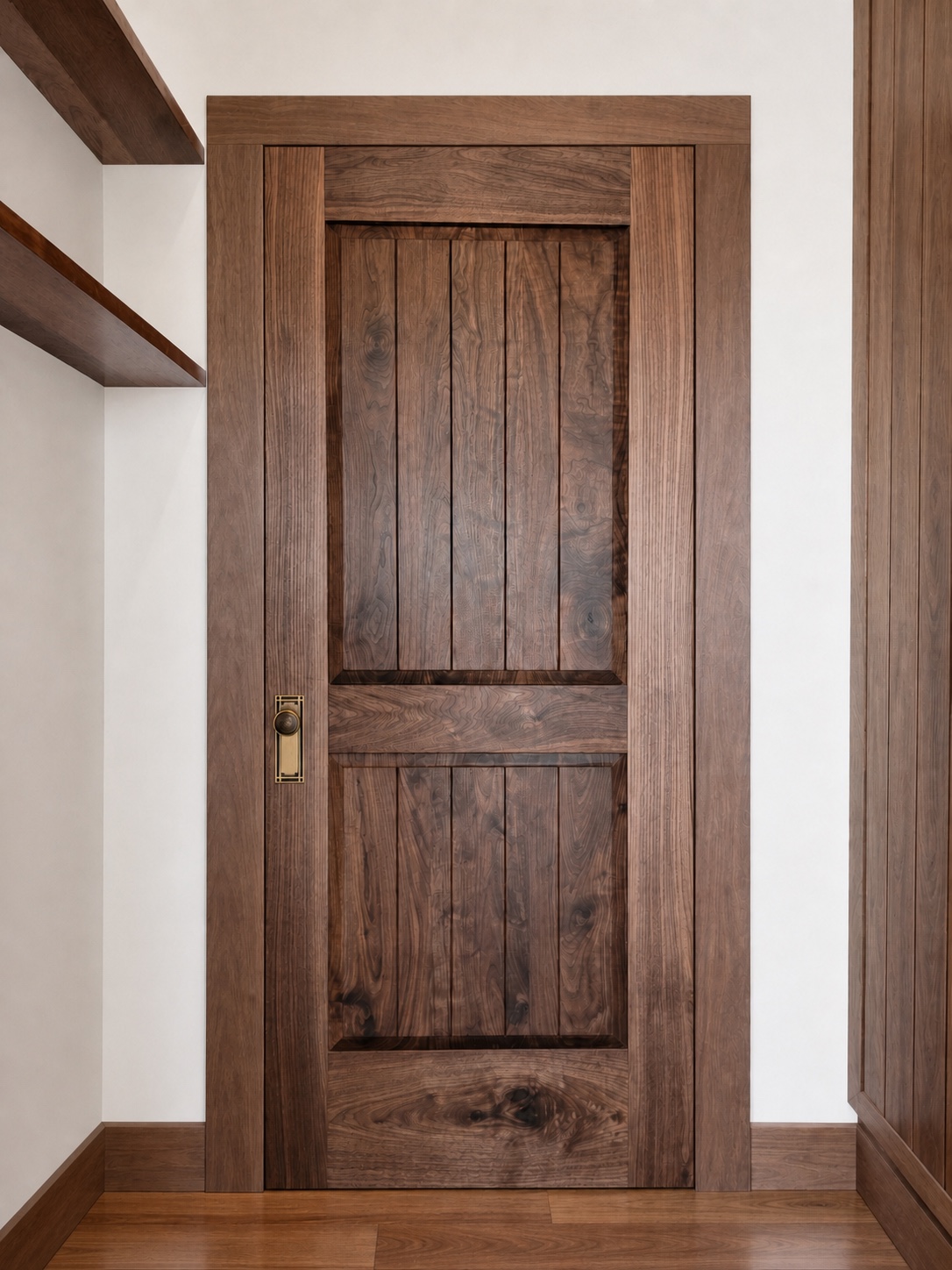 Raised walnut panel door with brass hardware