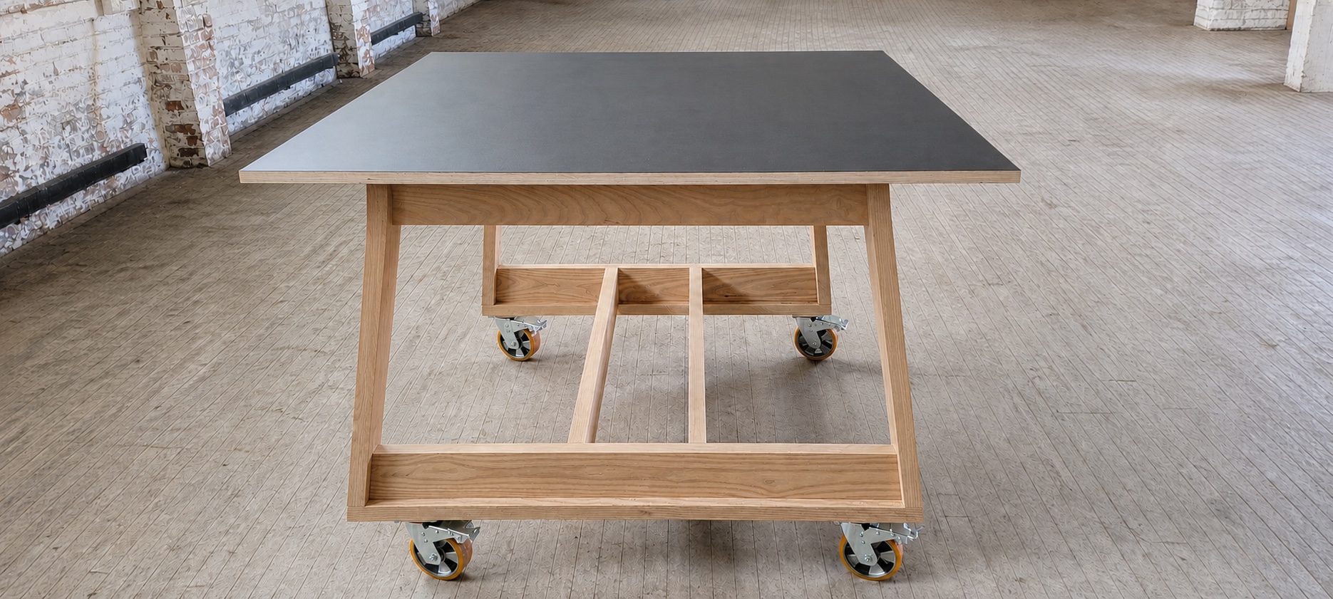 Black-topped MWS rolling work table in an industrial interior